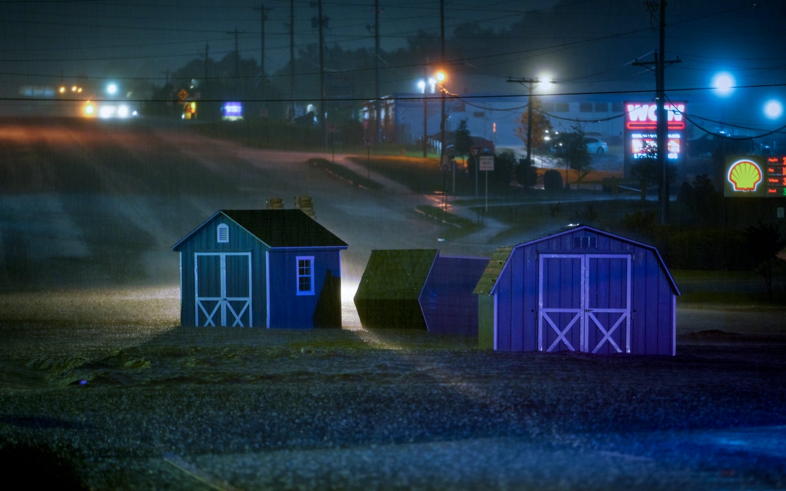 Three sheds sit in the middle of North Marrietta parkway. Flood waters engulfed multiple roads in Cobb county early Wednesday morning. Ben Hendren for the AJC
