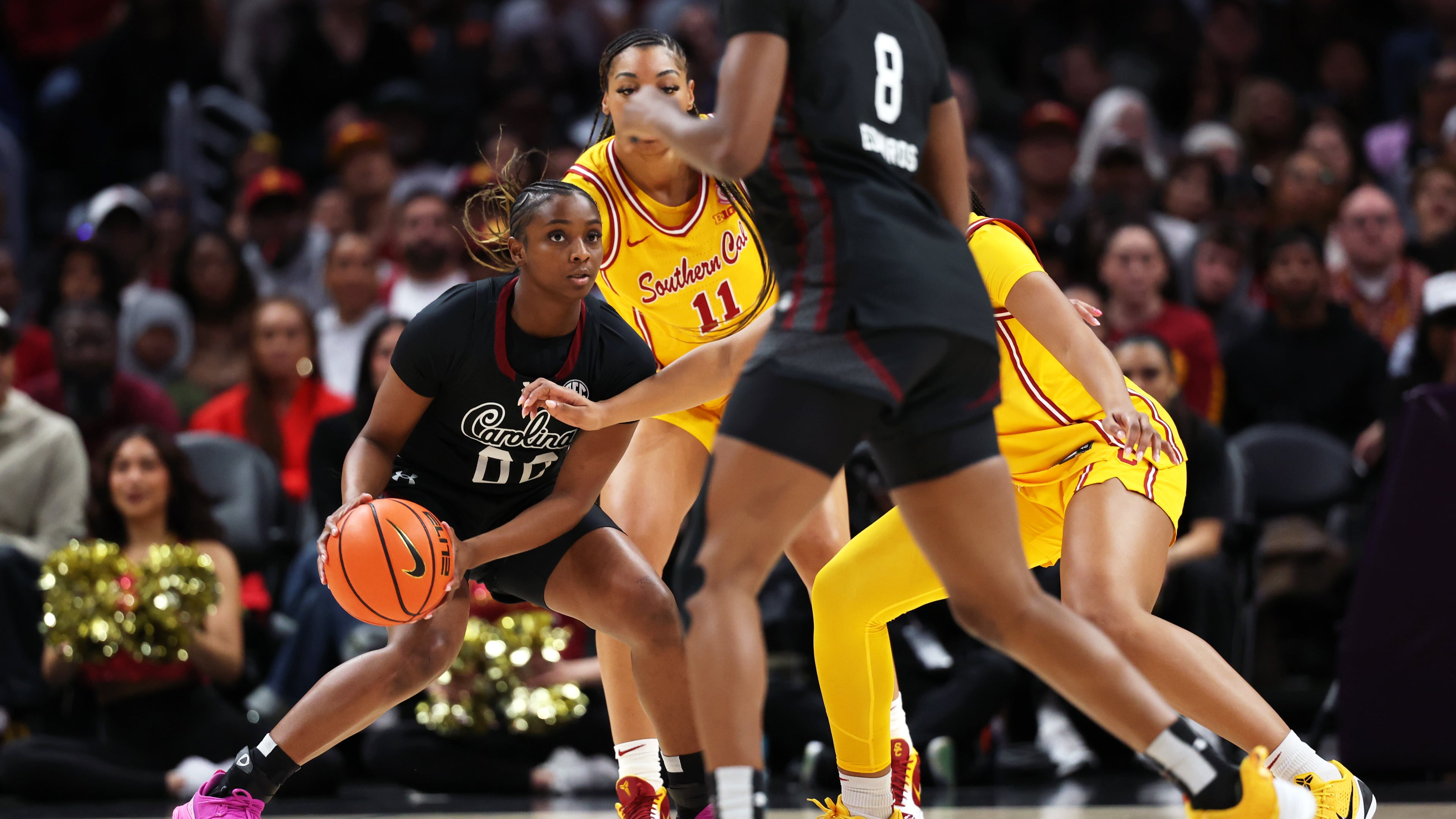 South Carolina guard Ta'Niya Latson, left, looks to pass the ball against Southern California during the first half of an NCAA college basketball game Saturday, Nov. 15, 2025, in Los Angeles. (AP Photo/Allison Dinner)