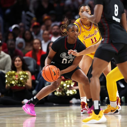 South Carolina guard Ta'Niya Latson, left, looks to pass the ball against Southern California during the first half of an NCAA college basketball game Saturday, Nov. 15, 2025, in Los Angeles. (AP Photo/Allison Dinner)