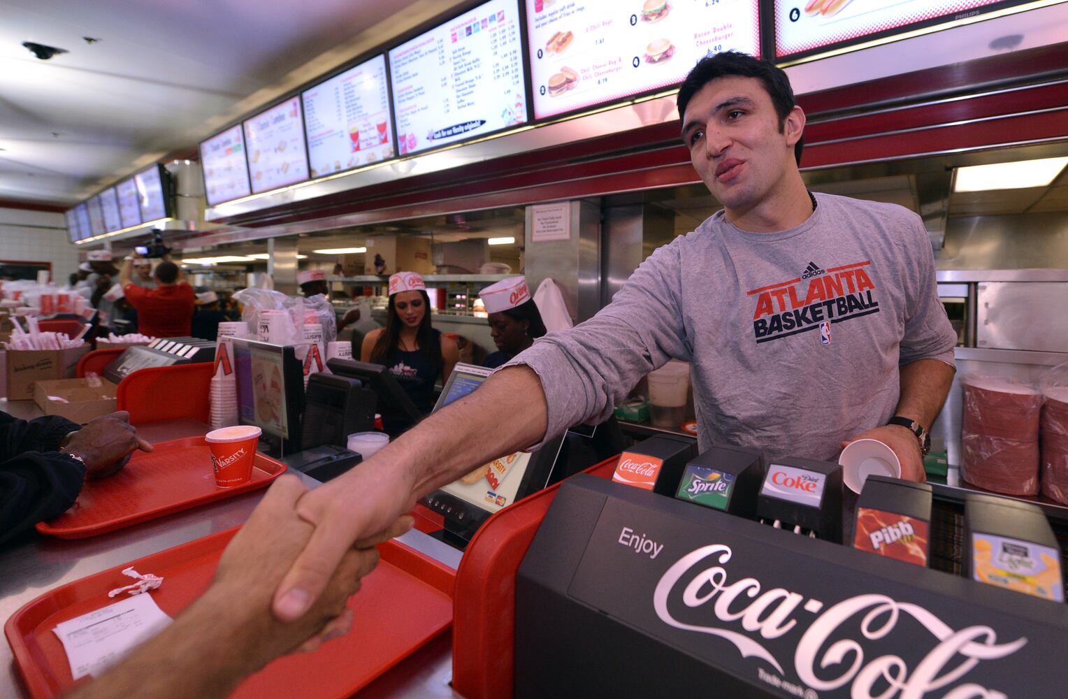 Zaza greets a customer