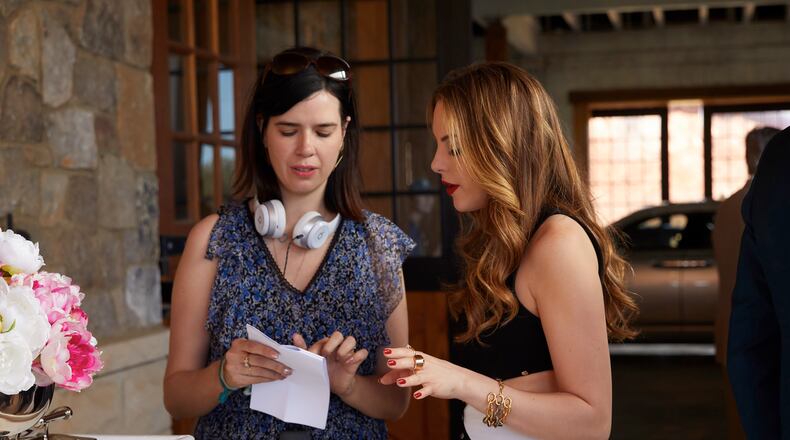 Westminster grad Sallie Patrick (left) runs "Dynasty" on the CW. Here, she consults with star Elizabeth Gillies, who plays Fallon Carrington. CREDIT: the CW