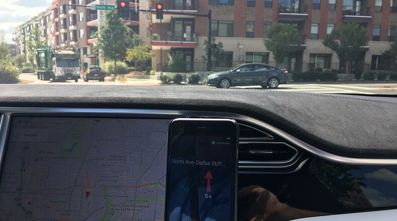 The Travel Safely application is demonstrated by A.I. President Bryan Mulligan while driving his autonomous Tesla Model S on North Avenue. Doug Turnbull for the AJC