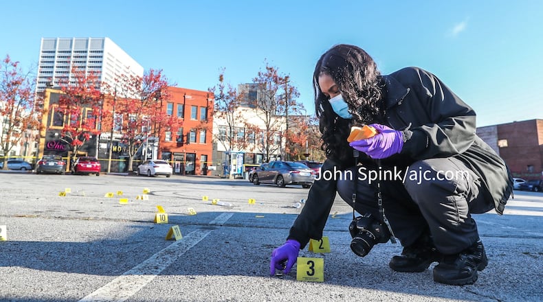 Atlanta police crime scene technician K. Gallagher collected more than 30 shell casings in the parking lot across from the Monaco Hookah Lounge.