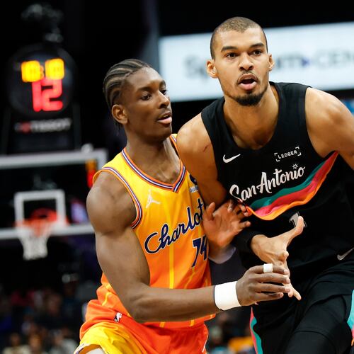 San Antonio Spurs forward Victor Wembanyama, right, moves the ball against Charlotte Hornets forward Moussa Diabate during the first half of an NBA basketball game in Charlotte, N.C., Saturday, Jan. 31, 2026. (AP Photo/Nell Redmond)