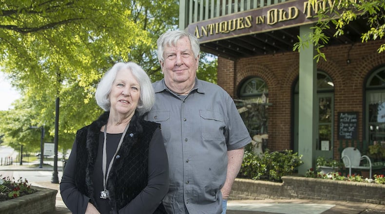Antiques in Old Town owners Rowann (left) and Hugh Wilkerson pose for a photo at their business in downtown Lilburn. They closed for more than a month amid concerns about the pandemic. (ALYSSA POINTER / ALYSSA.POINTER@AJC.COM)