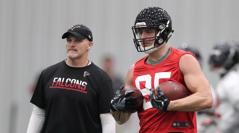 Atlanta Falcons tight end Eric Saubert and head coach Dan Quinn watch a play during organized team activities on Tuesday, May 22, 2018, in Flowery Branch. Curtis Compton/ccompton@ajc.com