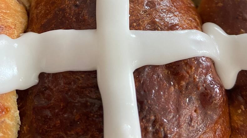 Soaked fruit, spices, and a touch of sweetness from a confectioner's glaze make these spring buns a classic springtime baking project.