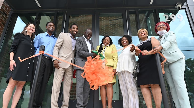 July 1, 2021 Atlanta - Leonard Adams, Jr. (center left), Founder of Quest Community Development Organization,  and Olivia D.A. Maxwell (center right), executive director of On the Rise Financial Center, cut the ribbon during an opening event of On the Rise Financial Center and Quest Westside Impact Center in Atlanta on Thursday, July 1, 2021. On The Rise Financial Center opens a new office and community space in a new building near the corner of Joseph E. Boone Boulevard and Joseph E. Lowery Boulevard. The On The Rise center assists residents with one-on-one financial coaching, including preparation for buying a home or starting a new business. It also gives people access to local credit union products including banking services. The center is supported financially though Equifax, as well as Invest Atlanta and the Arthur M. Blank Foundation. (Hyosub Shin / Hyosub.Shin@ajc.com)