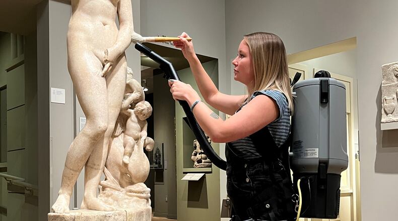 Objects conservator Ella Andrews vacuums a marble sculpture at the Michael C. Carlos Museum at Emory University. Photo: Courtesy of Carlos Museum