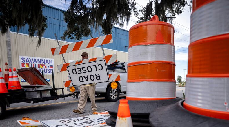 SAVANNAH, GA - AUGUST 29, 2023: Chatham County Public Works employee Richard McCoy puts barrels, cones and road closure signs out for the police department, Tuesday, Aug., 29, 2023 ahead of Hurricane Idalia's arrival. Officials may have to close the main causeway, Highway 80, to Tybee Island, if it's covered by high water. (AJC Photo/Stephen B. Morton)