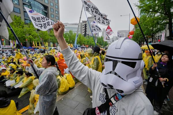 A member of the Korean Confederation of Trade Unions wearing a Star Wars mask shouts slogans during a rally on May Day in Seoul, South Korea, Thursday, May 1, 2025. (AP Photo/Ahn Young-joon)