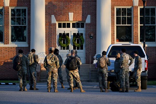 Military personnel at Plains High School Visitor Center and Museum on Friday. (Hyosub Shin / AJC)