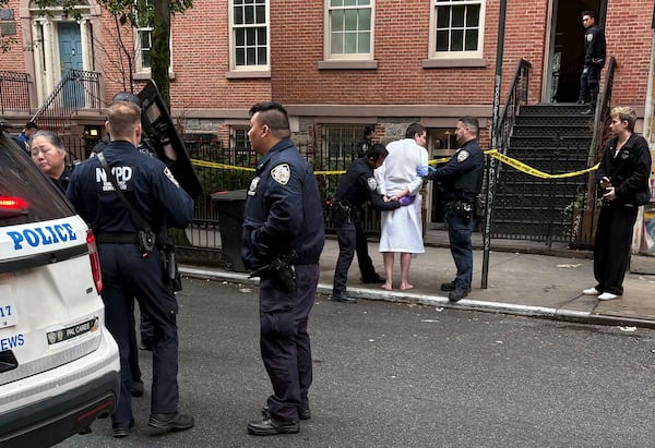 New York police officers arrest John Woeltz, Friday, May 23, 2025, in New York, who was charged with kidnapping, assaulting and holding a man against his will for several weeks in an upscale Manhattan town house.(AP Photo/Kava Gorna via AP)