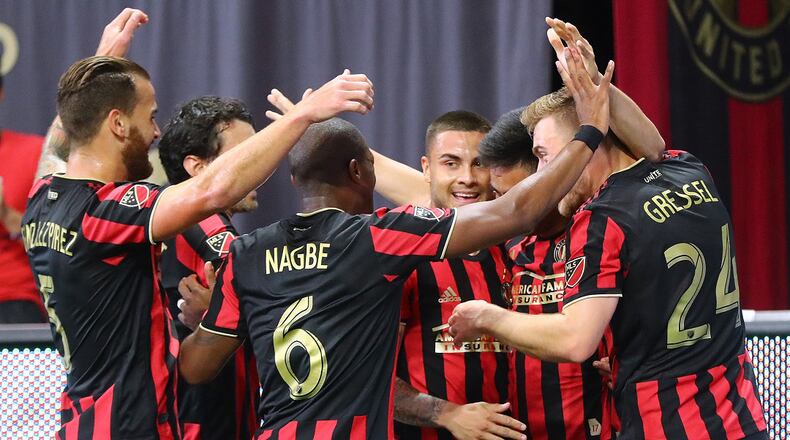 Atlanta United players mob midfielder Pity Martinez to help him celebrate after he scored his first goal of the season against Orlando City in a MLS soccer match on Sunday, May 12, 2019, in Atlanta.  Curtis Compton/ccompton@ajc.com