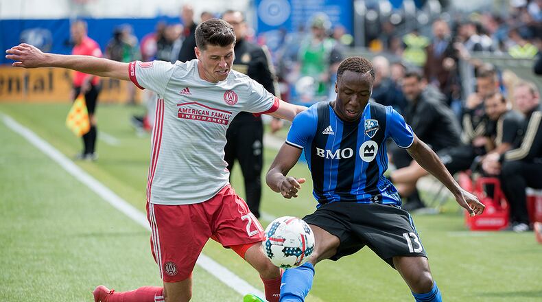 Montreal Impact’s Ballou Jean-Yves Tabla, right, challenges Atlanta United’s Mark Bloom during second-half MLS soccer game action in Montreal, Saturday, April 15, 2017. (Graham Hughes/The Canadian Press via AP)