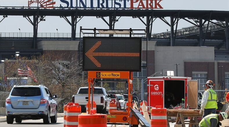 Traffic negotiates closed lanes as construction continues on Windy Ridge Parkway to SunTrust Park on the bridge over I-75 on Thursday, March 23, 2017, in Atlanta. AJC photo: Curtis Compton