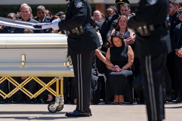 The wife of South Fulton Police Department Captain Helio Garcia during his funeral in April. Garcia is one of three Georgia officers who have lost their lives in the line of duty in 2025. 