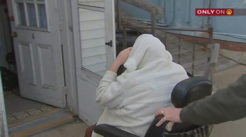 Barbara Bolt, the mother of accused Pittsburgh synagogue gunman, Robert Bowers, hides her face as a friend wheels her away from inquiring reporters.