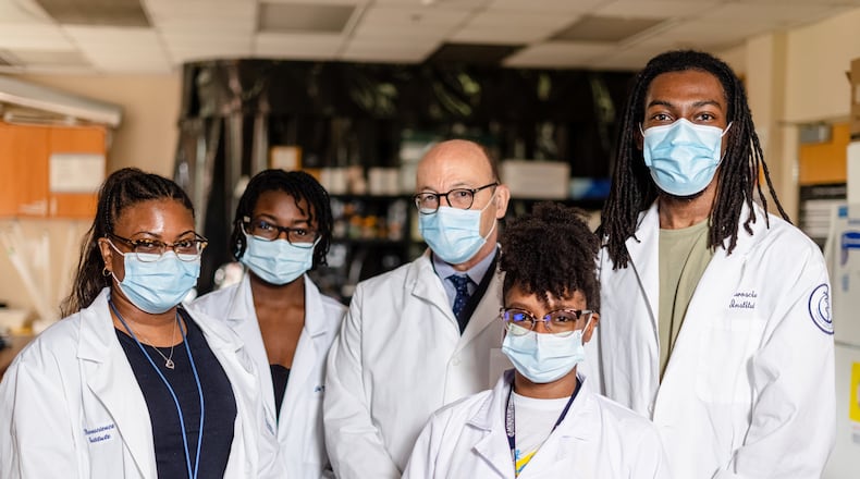 Morehouse School of Medicine chief scientific research officer, Dr. Gianluca Tosini, center, with students.