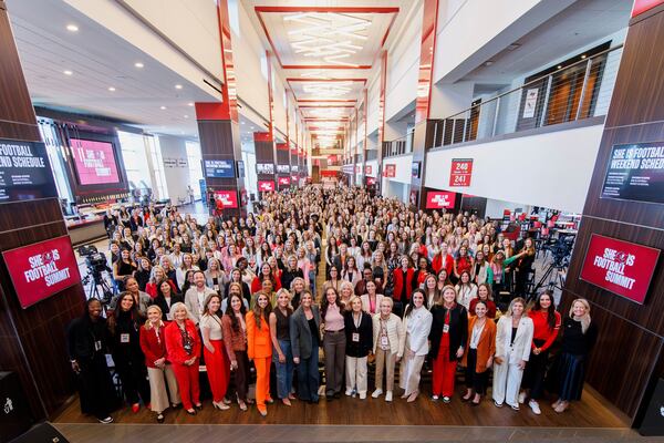In this image provided by the Tampa Bay Buccaneers, She Is Football Summit attendees gather in the concourse at Raymond James Stadium for a group photo, Friday, March 7, 2025, in Tampa. (Kyle Zedaker/Tampa Bay Buccaneers via AP)