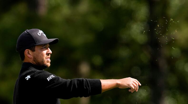 Xander Schauffele checks the wind on the first hole during the first round of the Masters golf tournament at the Augusta National Golf Club, Thursday, April 9, 2026, in Augusta, Ga. (AP Photo/Ashley Landis)