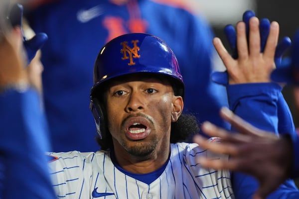 New York Mets' Francisco Lindor celebrates with teammates after hitting a home run during the first inning of a baseball game against the Philadelphia Phillies Monday, April 21, 2025, in New York. (AP Photo/Frank Franklin II)