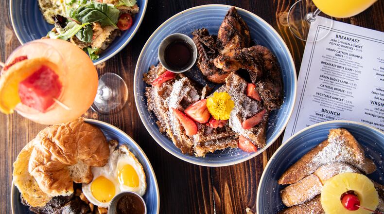 The Breakfast Boys in College Park is an all-day breakfast and brunch spot with dishes such as Jerk Chicken and Sweet Potato Waffles (center), Green Eggs and Lamb (upper left), Coffee Rubbed Steak and Eggs (lower left), and Pineapple Upside Down French Toast (lower right). (Mia Yakel for The Atlanta Journal-Constitution)