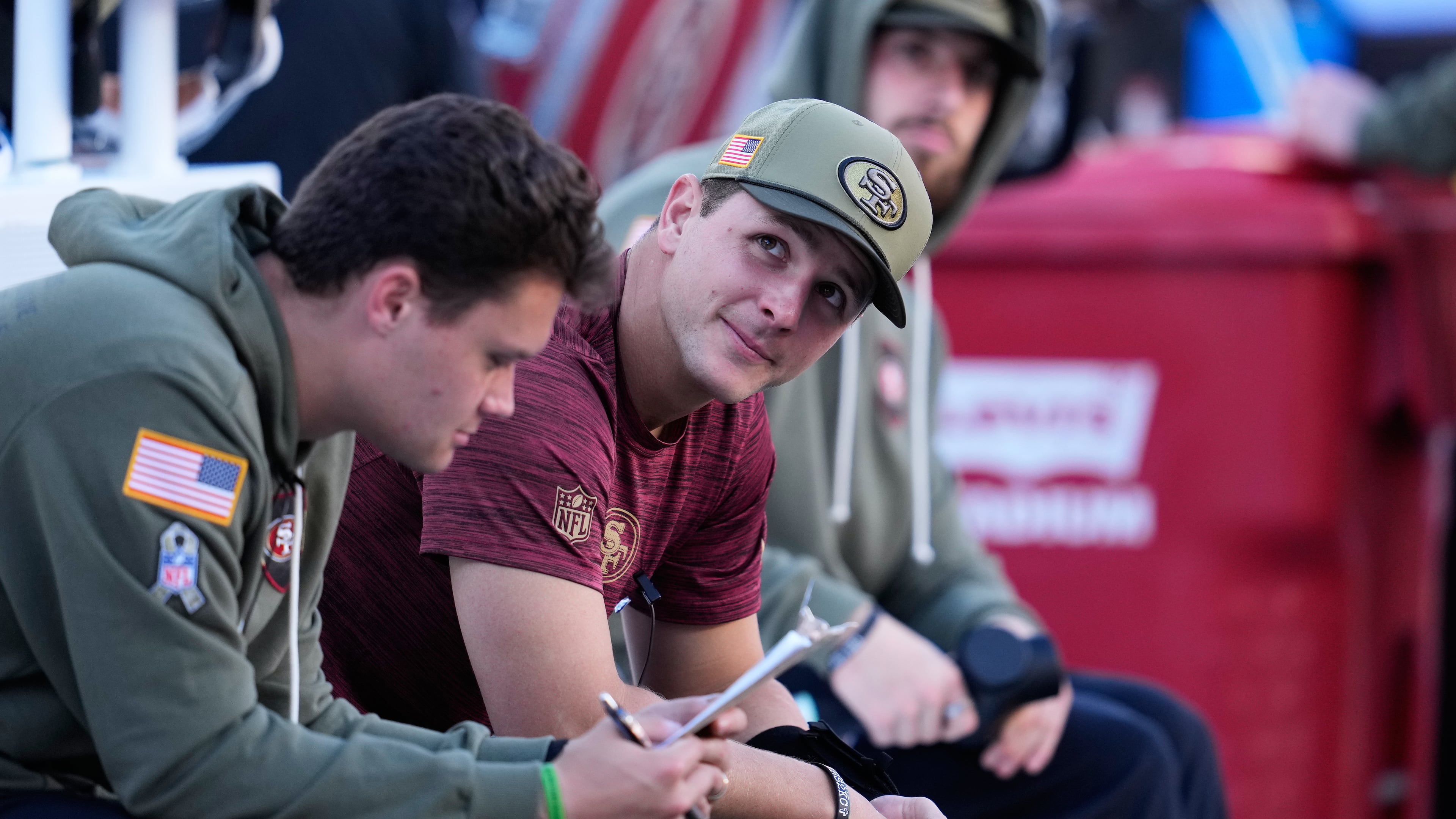 Injured San Francisco 49ers quarterback Brock Purdy, middle, sits on the bench during the first half of an NFL football game against the Los Angeles Rams in Santa Clara, Calif., Sunday, Nov. 9, 2025. (AP Photo/Godofredo A. Vásquez)