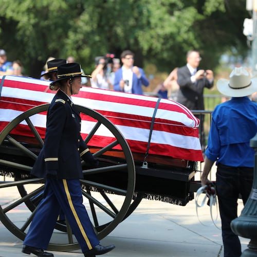 The flag-draped casket of U.S. Sen. Lindsey Graham, R-S.C., is carried on a horse-drawn caisson to his funeral at First Baptist Church in Columbia, S.C., on Wednesday, July 29, 2026. (AP Photo/Jeffrey Collins).