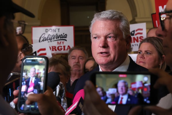 U.S. Rep. Mike Collins, a GOP Senate hopeful, speaks to reporters after filing paperwork to run for election at the Capitol.