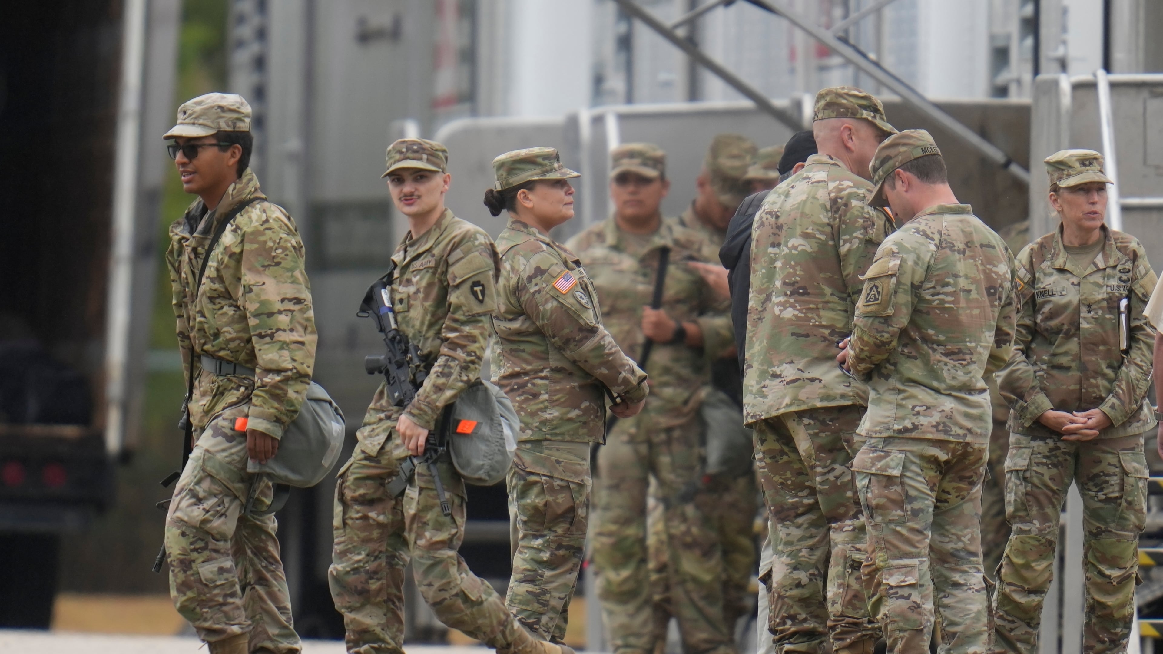 Military personnel in uniform, with the Texas National Guard patch on, are seen at the U.S. Army Reserve Center, Tuesday, Oct. 7, 2025, in Elwood, Ill., a suburb of Chicago. (AP Photo/Erin Hooley)