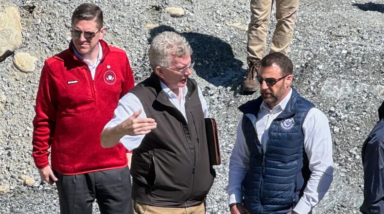 Homeland Security Secretary Markwayne Mullin, right, talks with Mayor Peter O'Leary, during a trip to survey damage caused by Hurricane Helene, Tuesday, April 7, 2026 in Chimney Rock, N.C. This is Mullin's first official trip since replacing Kristi Noem. (AP Photo Rebecca Santana)