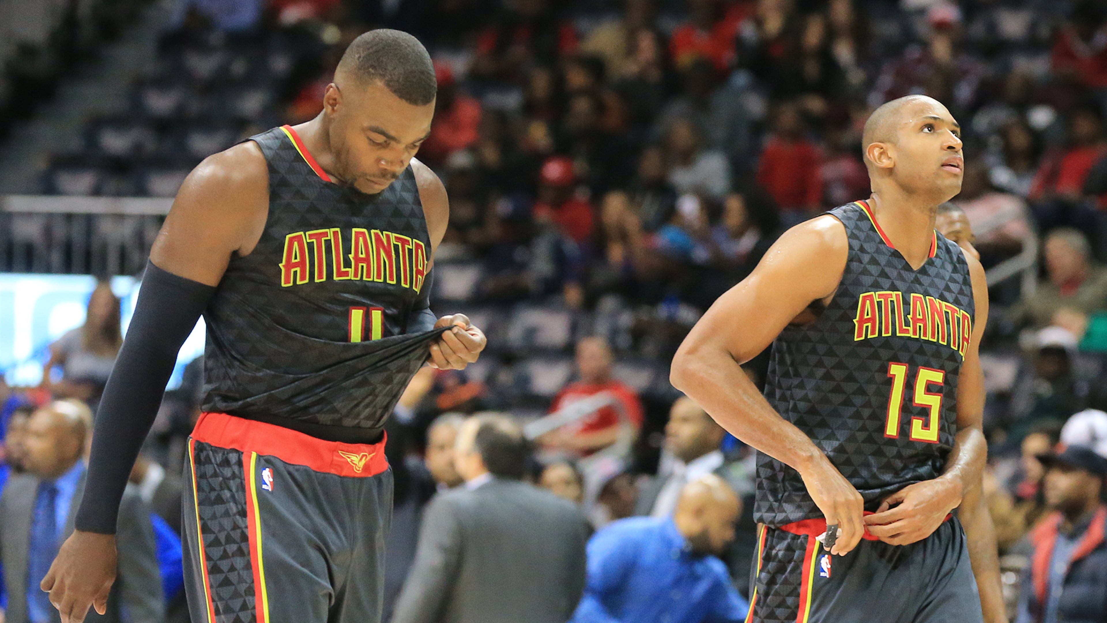 Hawks Paul Millsap (left) and Al Horford walk off the court falling 106-94 to the Pistons in their first regular season basketball game "home opener" on Tuesday, Oct. 27, 2015, in Atlanta. (Curtis Compton/AJC 2015)