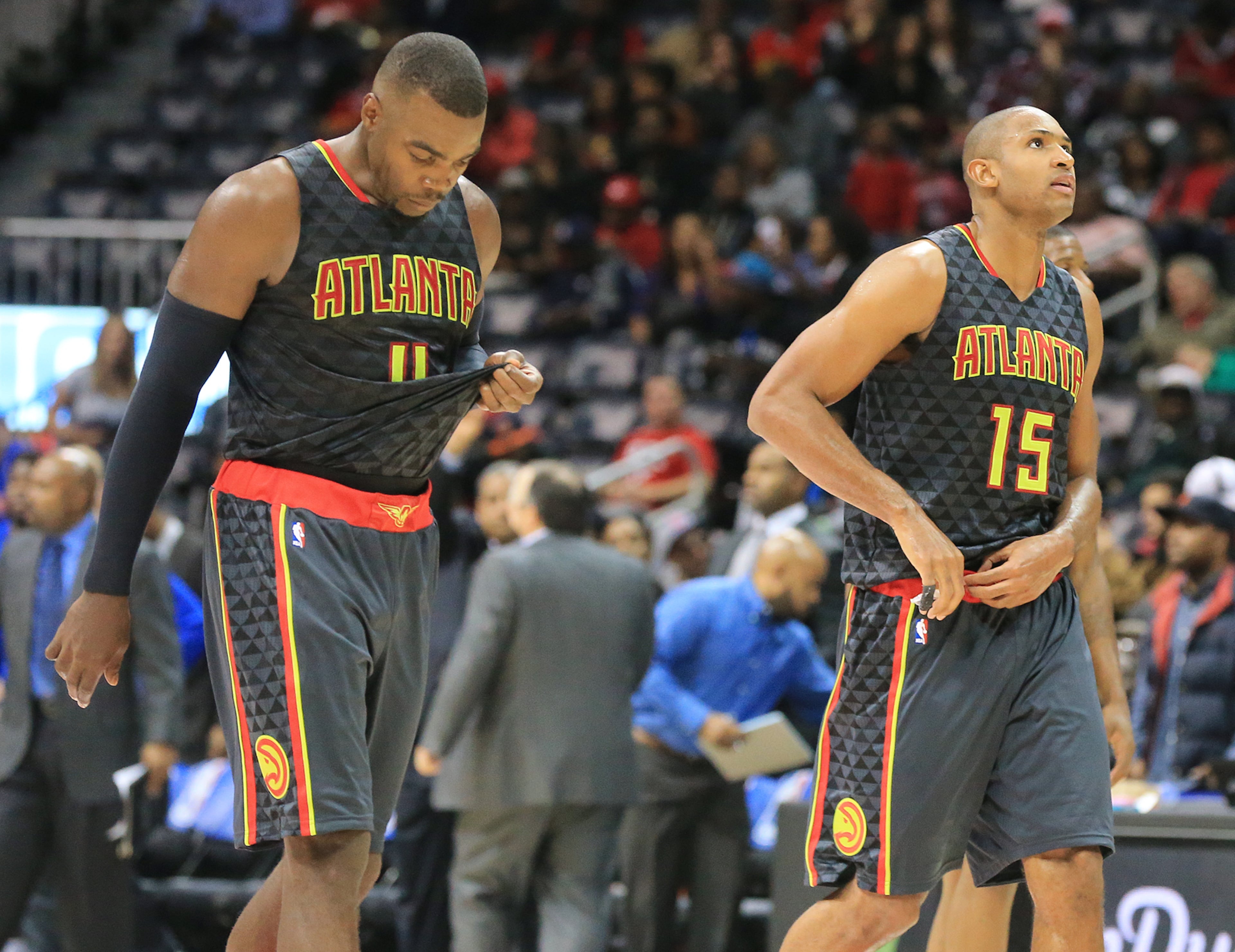 Hawks Paul Millsap (left) and Al Horford walk off the court falling 106-94 to the Pistons in their first regular season basketball game "home opener" on Tuesday, Oct. 27, 2015, in Atlanta. (Curtis Compton/AJC 2015)