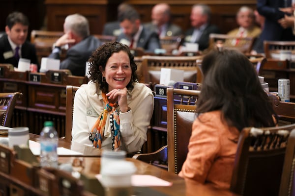 State Rep. Anne Allen Westbrook (left), a Democrat from Savannah, talks with a colleague on the second day of this year's legislative session at the Capitol in Atlanta.