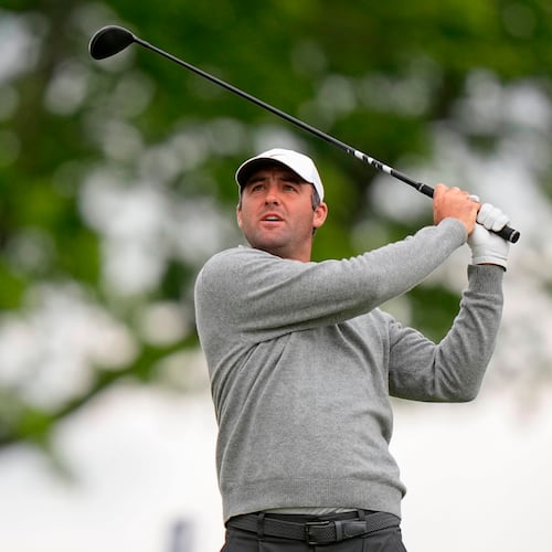 Fans watch Scottie Scheffler hits on the eighth green during the first round of the PGA Championship golf tournament at Aronimink Golf Club, Thursday, May 14, 2026, in Newtown Square, PA. (AP Photo/Frank Franklin II)