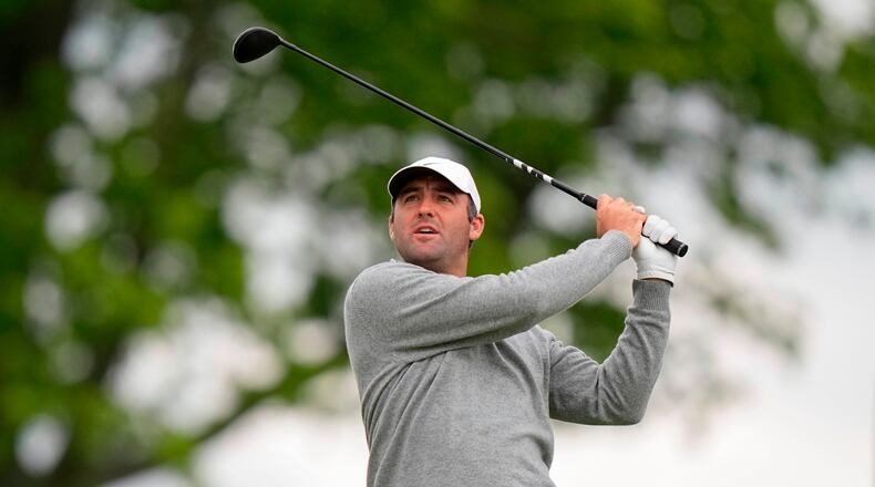 Fans watch Scottie Scheffler hits on the eighth green during the first round of the PGA Championship golf tournament at Aronimink Golf Club, Thursday, May 14, 2026, in Newtown Square, PA. (AP Photo/Frank Franklin II)