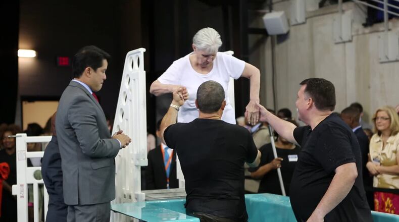 A woman gets baptized at one of the Jehovah Witnesses’ conferences in Georgia. CONTRIBUTED