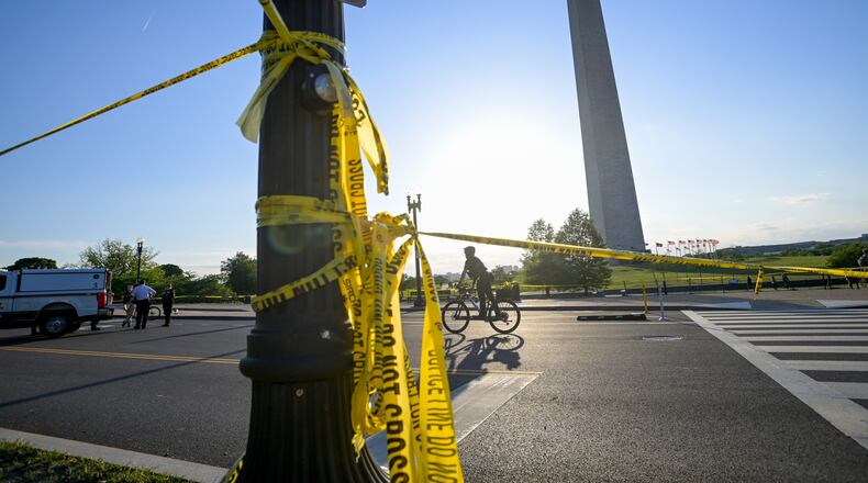 FILE - Police tape remains around the scene after a person was shot near the Washington Monument in May 4, 2026, in Washington. (AP Photo/Rod Lamkey Jr., File)