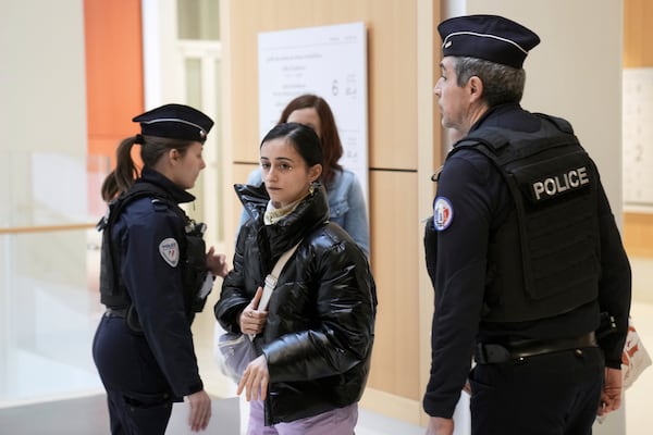 Actor Charlotte Arnould, center, arrives at the courtroom, while Depardieu, who is facing trial for the alleged sexual assaults of two women on a film set in 2021, arrives Monday, March 24, 2025 in Paris. (AP Photo/Thibault Camus)