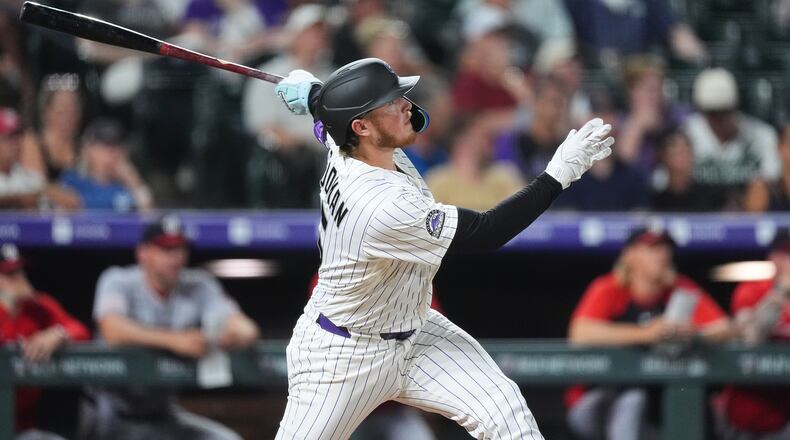 Colorado Rockies' Hunter Goodman follows the flight of his solo home run off Washington Nationals relief pitcher Clayton Beeter in the eighth inning of a baseball game Tuesday, July 21, 2026, in Denver. (AP Photo/David Zalubowski)