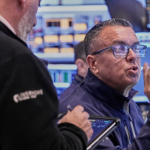 Trader Robert FInnerty Jr. works on the floor of the New York Stock Exchange, Thursday, Feb. 5, 2026. (AP Photo/Richard Drew)