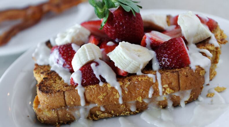 Firstlook at Reville Cafe in Marietta on Friday January 18, 2013. FOOD: Mystic Stuffed French Toast- sliced Hawaiian bread stuffed with cream cheese filling, coated with Kellogg's corn flakes, grilled then topped with strawberry and bananas, drizzled with vanilla rum sauce.