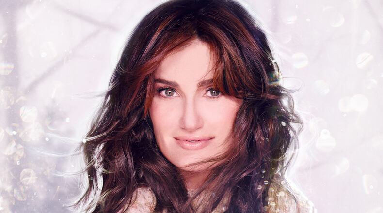 This CD cover image released by Warner Bros. Records shows "Holiday Wishes," by Idina Menzel. Menzel brings the soaring voice that made her famous this year in the Disney hit movie to her Christmas album "Holiday Wishes." The Tony Award-winner puts her own spin on holiday classics like "Silent Night" and "Do You Hear What I Hear?" (AP Photo/Warner Bros. Records)