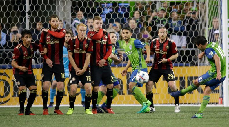 Atlanta United players make a wall as Seattle Sounders forward Nicolas Lodeiro, right, takes a free kick in the first half of an MLS soccer match, Friday, March 31, 2017, in Seattle. (AP Photo/Ted S. Warren)