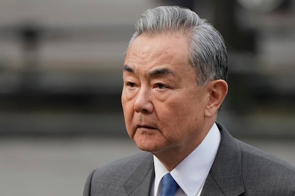 Chinese Foreign Minister Wang Yi attends a wreath-laying ceremony at the Tomb of the Unknown Soldier near the Kremlin wall in Moscow, Russia, Tuesday, April 1, 2025. (AP Photo/Alexander Zemlianichenko, Pool)