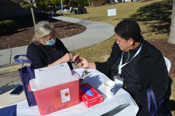GNR Public Health Director Dr. Audrey Arona conducts a blood glucose screening during Gwinnett County’s Stand Down event for military veterans at the county’s Veteran and Family Services Center on Nov. 4. (Photo Courtesy of Curt Yeomans)