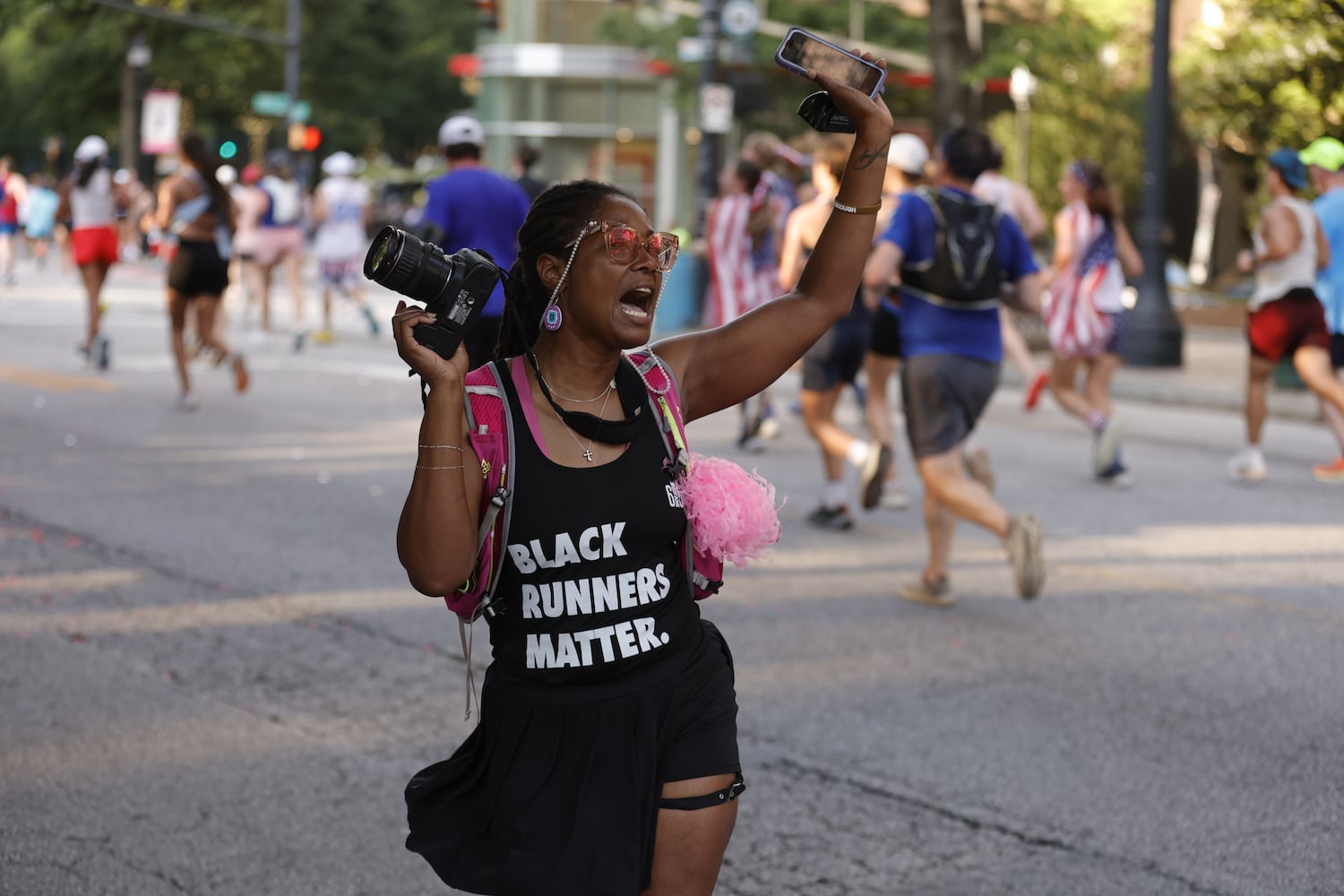 Ri’an Murphy, a member of 615 Run a black runners club in Nashville, celebrates at  the 56th running of the Atlanta Journal-Constitution Peachtree Road Race in Atlanta on Friday, July 4, 2025.   (Natrice Miller / AJC)