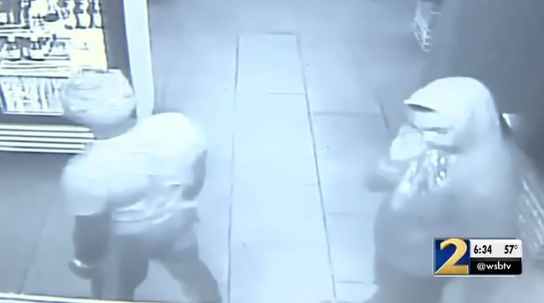 Surveillance video shows two of the men accused of robbing multiple metro Atlanta businesses.