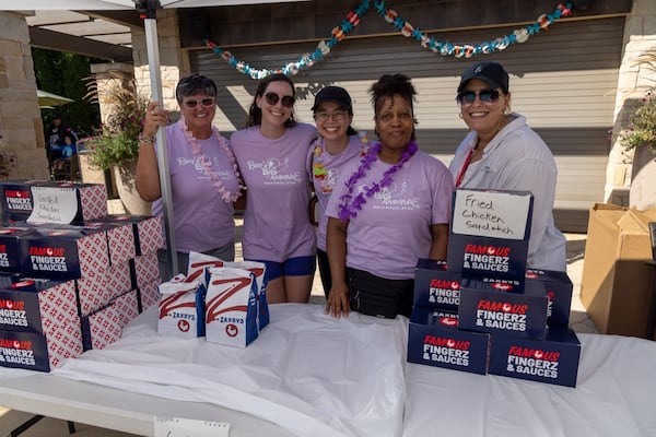 Latrice Moore (second from right) said she enjoys helping people and is pictured here helping at one of the family reunions organized by Bert's Big Adventure. (Courtesy of Gas South)